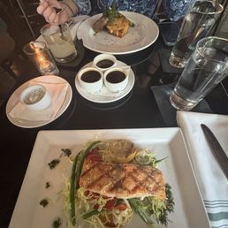 Bottom:Salmon with yogurt sauce on the side Top: Beef tenderloin Bottom:Salmon with yogurt sauce on the side Top: Beef tenderloin