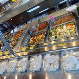 Chinese stir fried entrees in rear. Vietnamese pastry in front. Chinese stir fried entrees in rear. Vietnamese pastry in front.