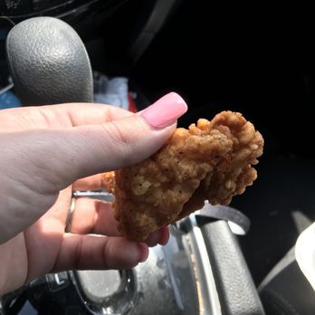 Charlie's Chicken - a hand holding a piece of fried chicken - Chicken Shop Near Me - Muskogee, Oklahoma