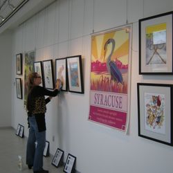 Edgewood Gallery - Cheryl Chappell installing a traveling exhibit for the Syracuse Poster Project at Upstate Cancer Center, February, 2017.