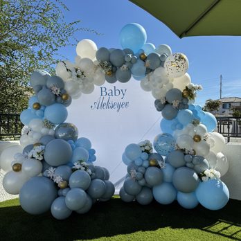 Air Up Balloons - Baby shower setup with blue, white, fog, and gold balloon garland, custom backdrop, and floral accents. - Balloon Services Near Me - Antelope, California
