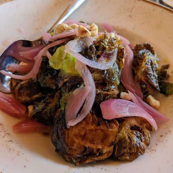 NINETEEN at TPC Sawgrass - Fried Brussels Sprouts. $15. Maple syrup & mustard vinaigrette, pickled onions + crushed hazelnut. Nineteen. - American Near Me - Ponte Vedra Beach, Florida NINETEEN at TPC Sawgrass - Fried Brussels Sprouts. $15. Maple syrup & mustard vinaigrette, pickled onions + crushed hazelnut. Nineteen. - American Near Me - Ponte Vedra Beach, Florida