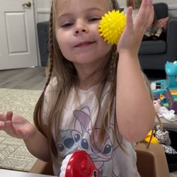 Tinymouth Feeding Therapy - Rolling a spiky ball on cheeks to integrate the rooting reflex and increase awareness of the sides of the mouth for chewing