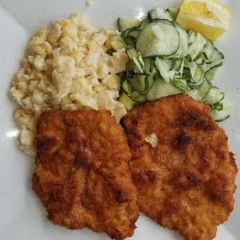 Max Bratwurst und Bier - Pork Schnitzel, Spatzel and Cucumber Salad.... lemon wedge - German Near Me - Astoria, New York