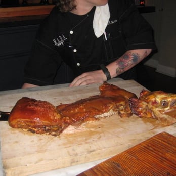 Amada - chef cutting up whole suckling pig tableside - Tapas Bars Near Me - Philadelphia, Pennsylvania