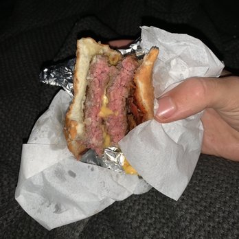 Five Guys - a person holding a sandwich in their hand - Burgers Near Me - Fair Oaks, California Five Guys - a person holding a sandwich in their hand - Burgers Near Me - Fair Oaks, California