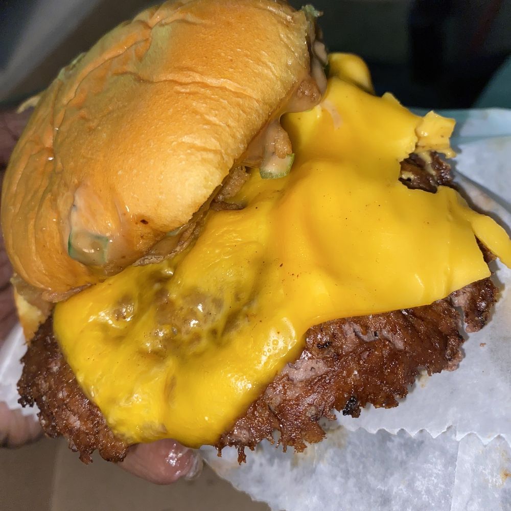 Shake Shack Dublin - a hand holding a cheeseburger - Burgers Near Me - Columbus, Ohio Shake Shack Dublin - a hand holding a cheeseburger - Burgers Near Me - Columbus, Ohio