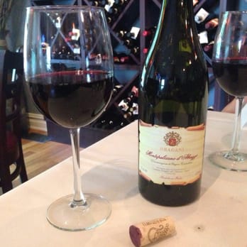 Aranci 67 - a bottle of wine and two glasses of wine - Italian Near Me - Wilton, Connecticut