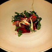 Photo of Red Medicine - Beverly Hills, CA, United States. Custard of fresh cream surrounded by anthocyanin roots, stalks, roasted walnut marzipan, dried cabbage, sour rhubarb juice