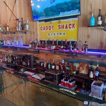 Caddy Shack - a bar with liquor bottles on the counter - New American Near Me - Spring, Texas