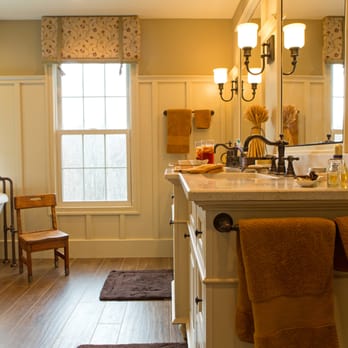JD Moore Construction - a bathroom with a tub and a chair - General Contractors Near Me - Lorton, Virginia