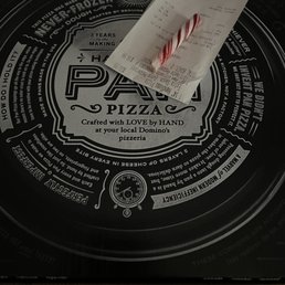 a candy cane on a pizza box a candy cane on a pizza box
