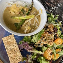 Seafood curry stew in a bowl of rice and side salad Seafood curry stew in a bowl of rice and side salad
