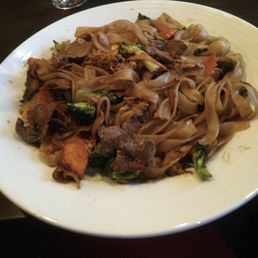 a plate of noodles with meat and vegetables