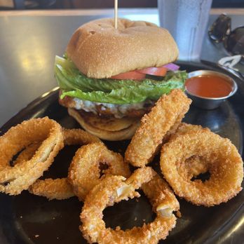 The Cliff Dwellers Restaurant - Grilled chicken sandwich tossed in Buffalo sauce with blue cheese and onion rings. Chicken was really tough which detracted a lot - New American Near Me - Marble Canyon, Arizona The Cliff Dwellers Restaurant - Grilled chicken sandwich tossed in Buffalo sauce with blue cheese and onion rings. Chicken was really tough which detracted a lot - New American Near Me - Marble Canyon, Arizona
