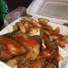 Chicken wings and fries with mambo , and egg roll Chicken wings and fries with mambo , and egg roll