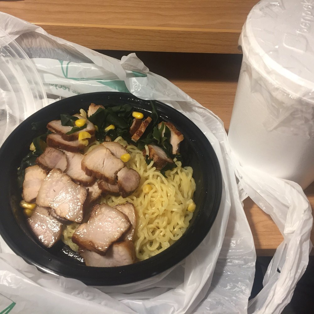 a bowl of noodles and a drink