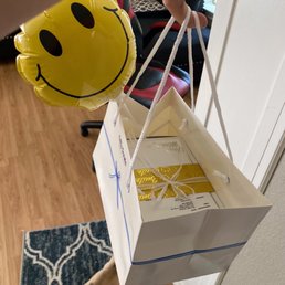 a person holding a box with a smiley face on it a person holding a box with a smiley face on it