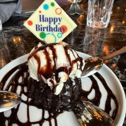 Chocolate cake with vanilla ice cream and chocolate sauce for our birthday girl.