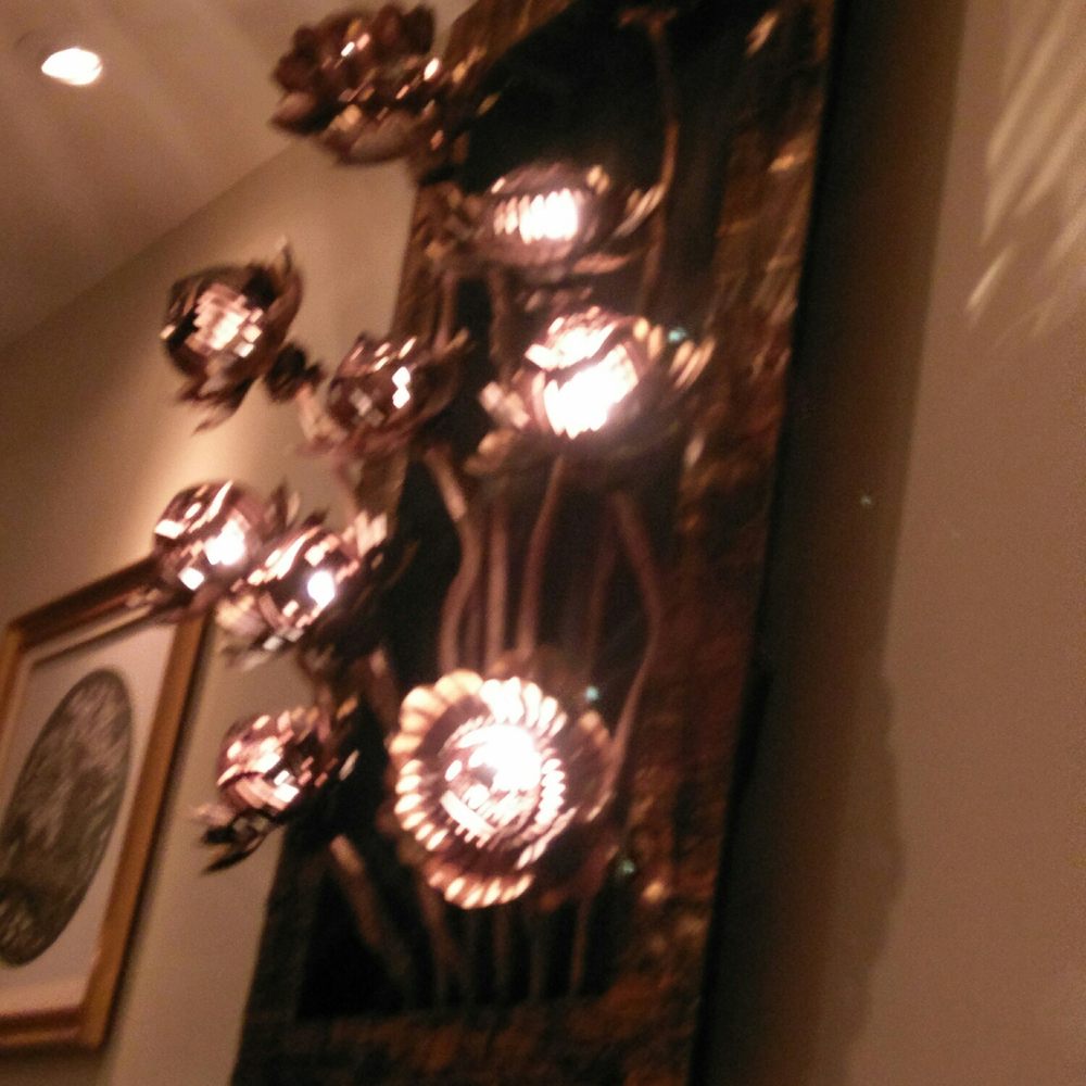 Thai Onzon - a wall sconce with flowers and candles - Thai Near Me - Cochrane, Alberta Thai Onzon - a wall sconce with flowers and candles - Thai Near Me - Cochrane, Alberta