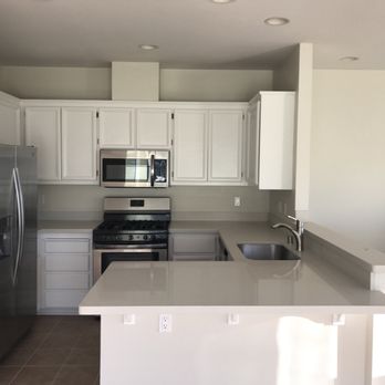 Artisan Builders Group - a kitchen with white cabinets and stainless steel appliances - General Contractors Near Me - San Jose, California