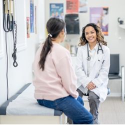FPA Women's Health - Berkeley - A doctor sits with a patient in a clean, welcoming exam room, creating a warm and supportive atmosphere focused on personalized car