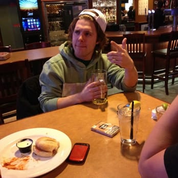 Boston Pizza - a man sitting at a table with a plate of pizza and a glass of beer - Pizza Near Me - Regina, Saskatchewan Boston Pizza - a man sitting at a table with a plate of pizza and a glass of beer - Pizza Near Me - Regina, Saskatchewan