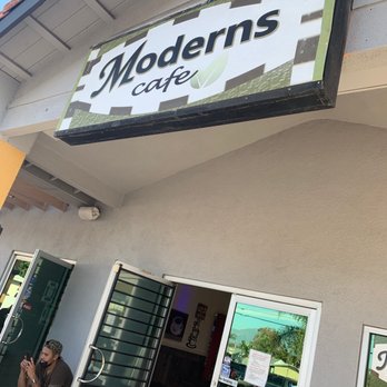 Moderns Cafe - a woman sitting on a bench in front of a cafe - Juice Bars & Smoothies Near Me - La Puente, California