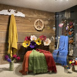 A cozy vignette featuring handmade felted wool flowers and upcycled cotton throws.