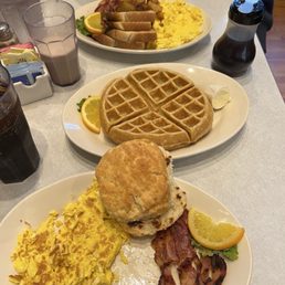 Eggs, biscuit, toast, bacon, home fries, and waffle
