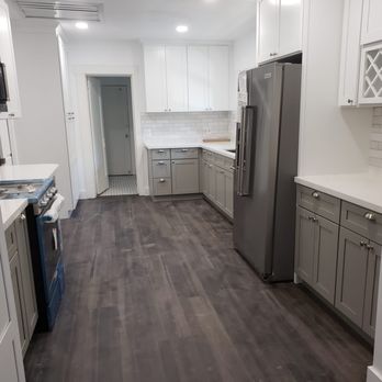 BroBuildersRenovations - a kitchen with white cabinets and wood floors - General Contractors Near Me BroBuildersRenovations - a kitchen with white cabinets and wood floors - General Contractors Near Me