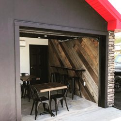 Roseland Coffee Bar - Garage door goes up on nice days! We have a custom epoxy bar top against our focal barn wood wall.