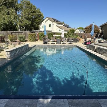 Quality Pool & Construction Inc - Pool with waterfall, Baja deck and deep spa with overflow waterfall. - Pool & Hot Tub Service Near Me Quality Pool & Construction Inc - Pool with waterfall, Baja deck and deep spa with overflow waterfall. - Pool & Hot Tub Service Near Me