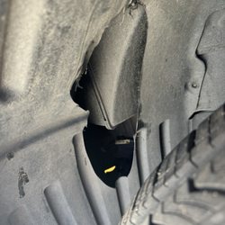 Technician purposely cut and ruined the fender well cover during an oil and replacing 4 new tires