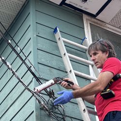 ABC Pest Services - Applying shoo bird to wires to help with controlling perching.
