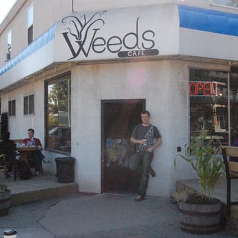 Weeds Cafe - a woman standing in front of a store - Coffee & Tea Near Me - Calgary, Alberta Weeds Cafe - a woman standing in front of a store - Coffee & Tea Near Me - Calgary, Alberta
