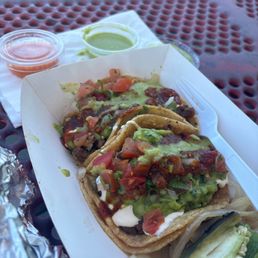 Two super tacos de asada. Really good! I like the spices of the green salsa!!