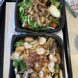 Two chicken salads: one with grilled chicken and the other with regular chicken nuggets Two chicken salads: one with grilled chicken and the other with regular chicken nuggets