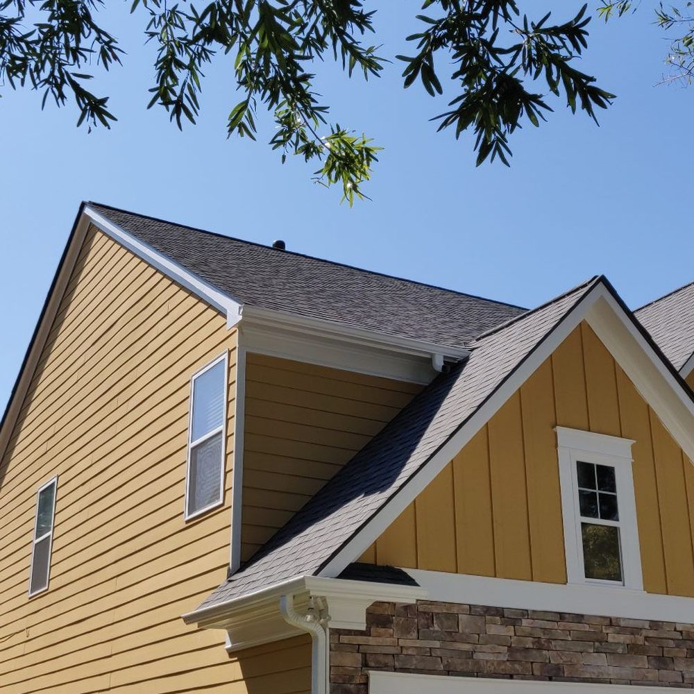 ER General Remodeling - a house with a ladder in front of it - General Contractors Near Me