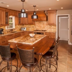 Lang's Kitchen & Bath - Traditional kitchen design with tumbled marble backsplash and maple cabinetry.