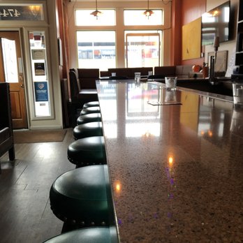 Nighthawk Chicago - a long bar with black stools - Coffee & Tea Near Me - Chicago, Illinois