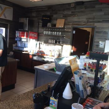 The Fix - a man standing at a counter in a restaurant - Desserts Near Me - Draper, Utah