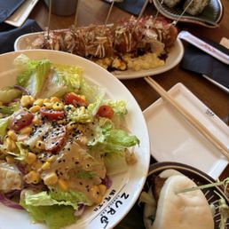House salad, Bao buns, Takoyaki, and Onigiri House salad, Bao buns, Takoyaki, and Onigiri