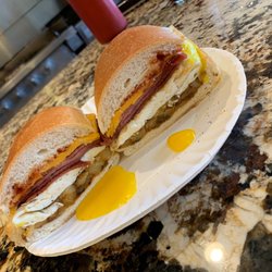 Breakfast sandwich with Taylor ham, over easy egg, cheese, and home fries