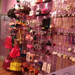 Sweet Poison Cupcake Designs - Accessory wall with bags, hats, jewelry and misc. items.