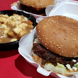 a hamburger and french fries on a red table a hamburger and french fries on a red table