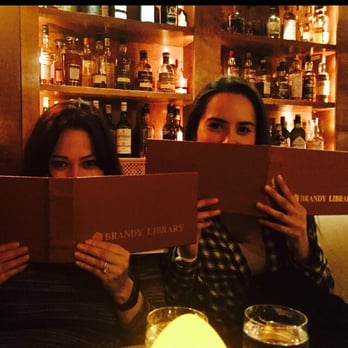 Brandy Library - Studying the menu - New American Near Me - New York, New York Brandy Library - Studying the menu - New American Near Me - New York, New York
