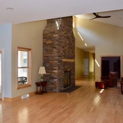 Harlan-McGee of North America - Gorgeous double height living room with stone fire place.