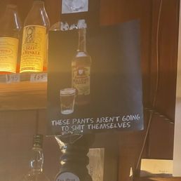 bottles of liquor and a sign bottles of liquor and a sign