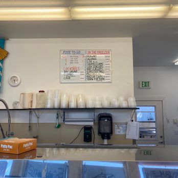 Krab Kettle - a display of coffee cups on a shelf - Seafood Markets Near Me - Florence, Oregon